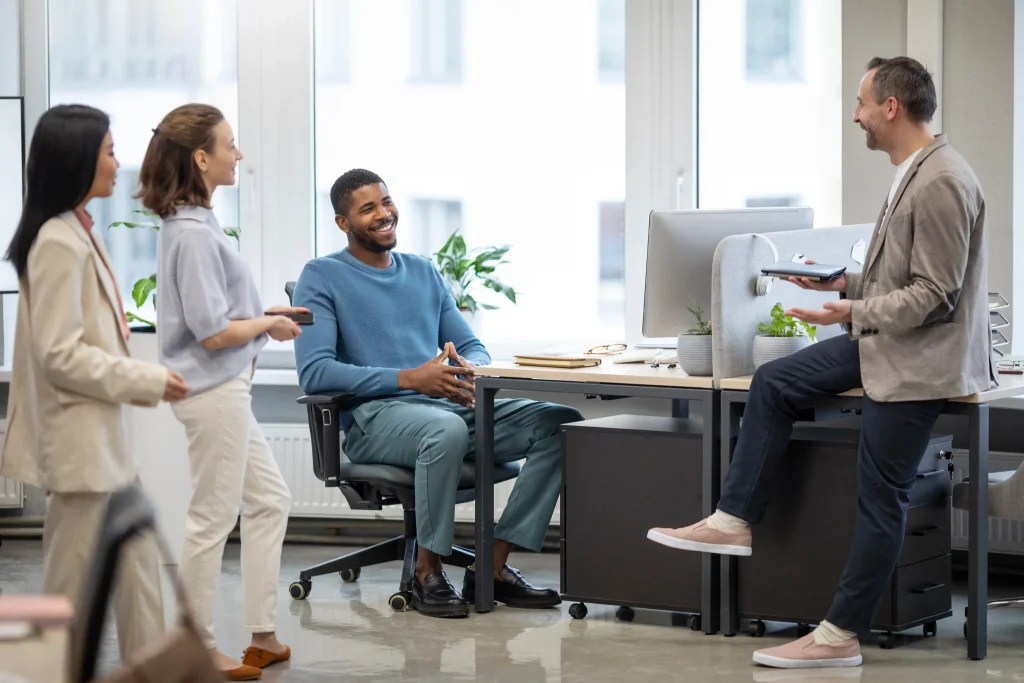 Happy employees working together in a clean modern office showing positive workplace morale