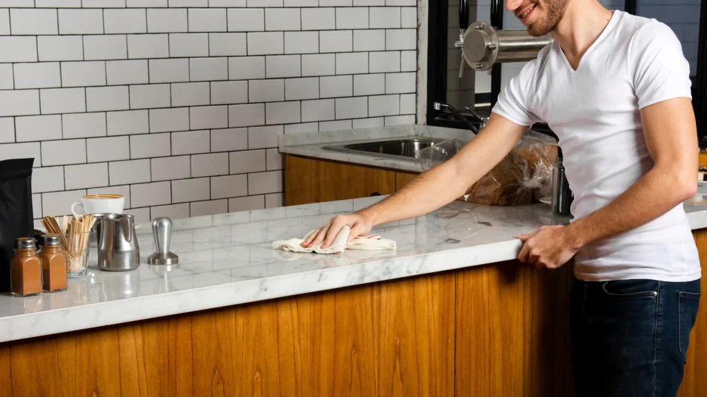 Post-renovation cleanup man cleaning countertop after remodel