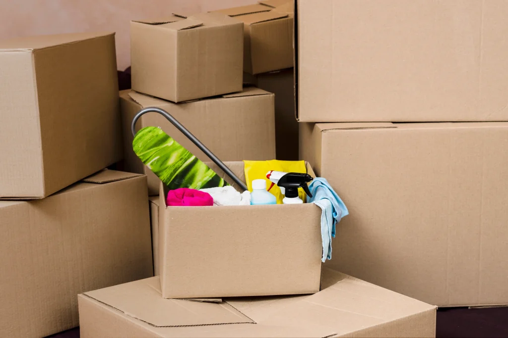 Cardboard boxes packed in a living room during move-out cleaning process