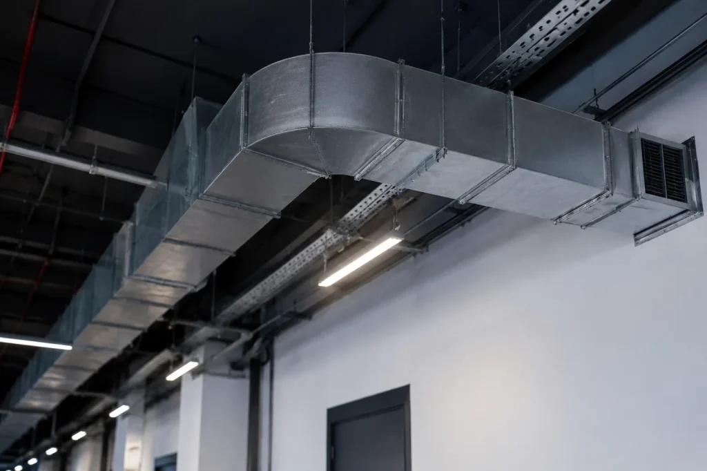 Industrial ceiling duct system showing clean metal vents for post-renovation duct cleaning.